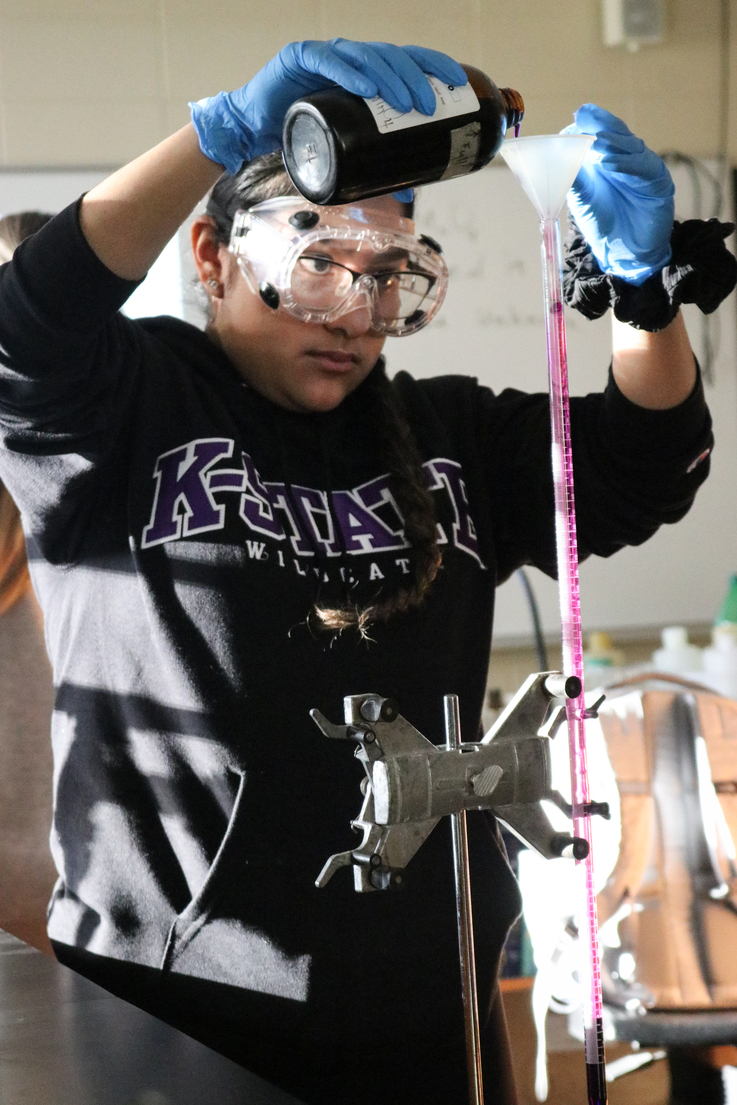 Chemistry students measuring chemicals