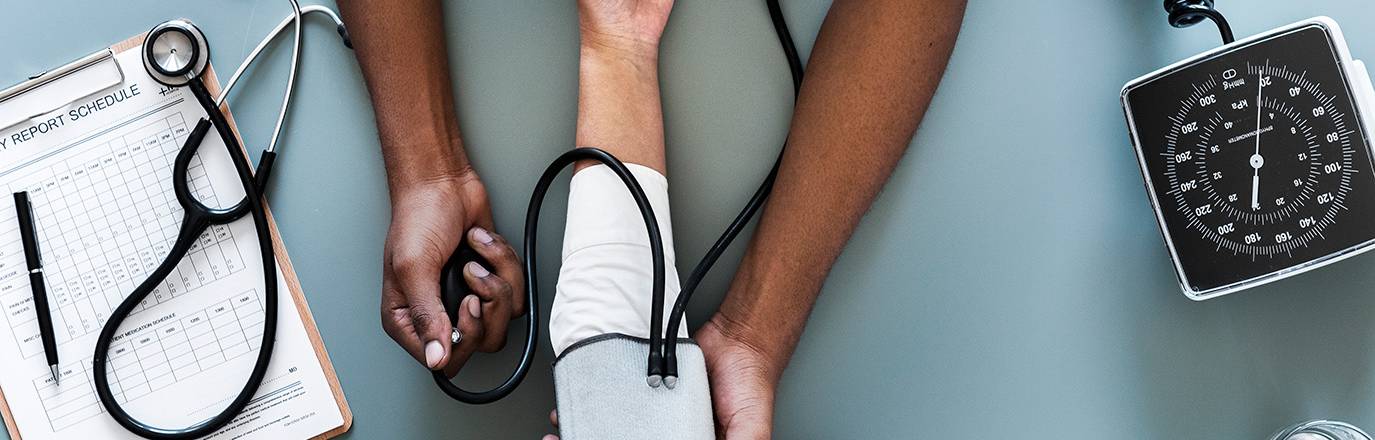 Stock photo of a nurse measure blood pressure