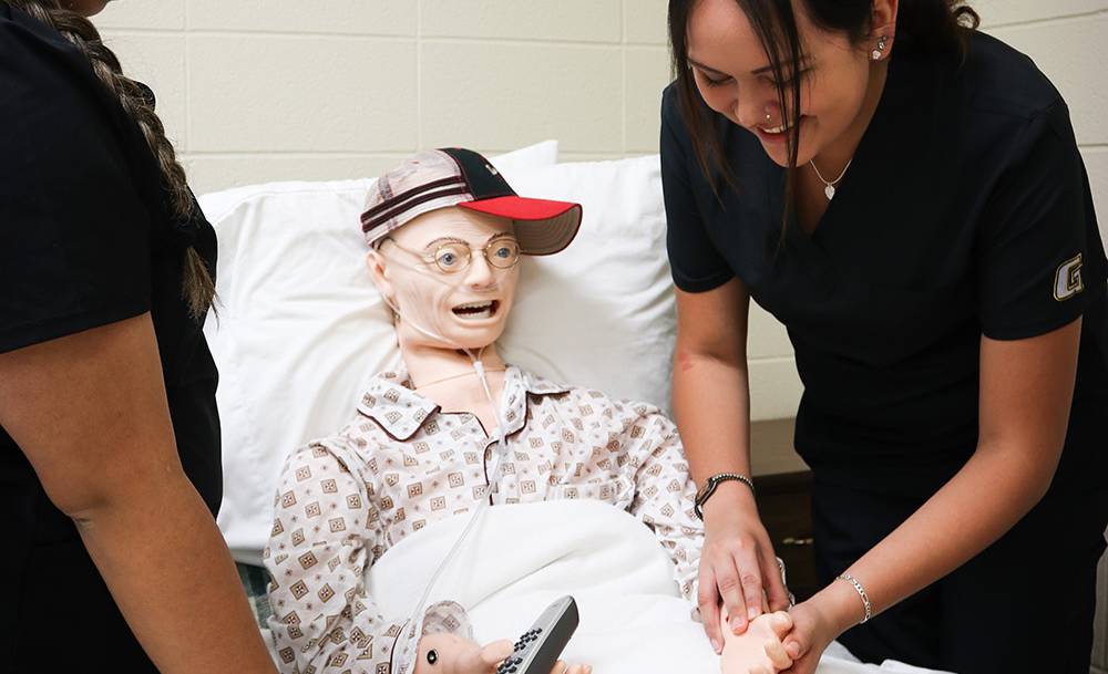 Two students practicing taking pulse