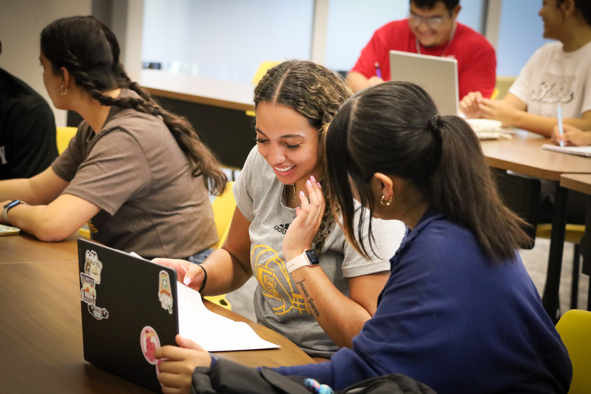 two students sitting at table.