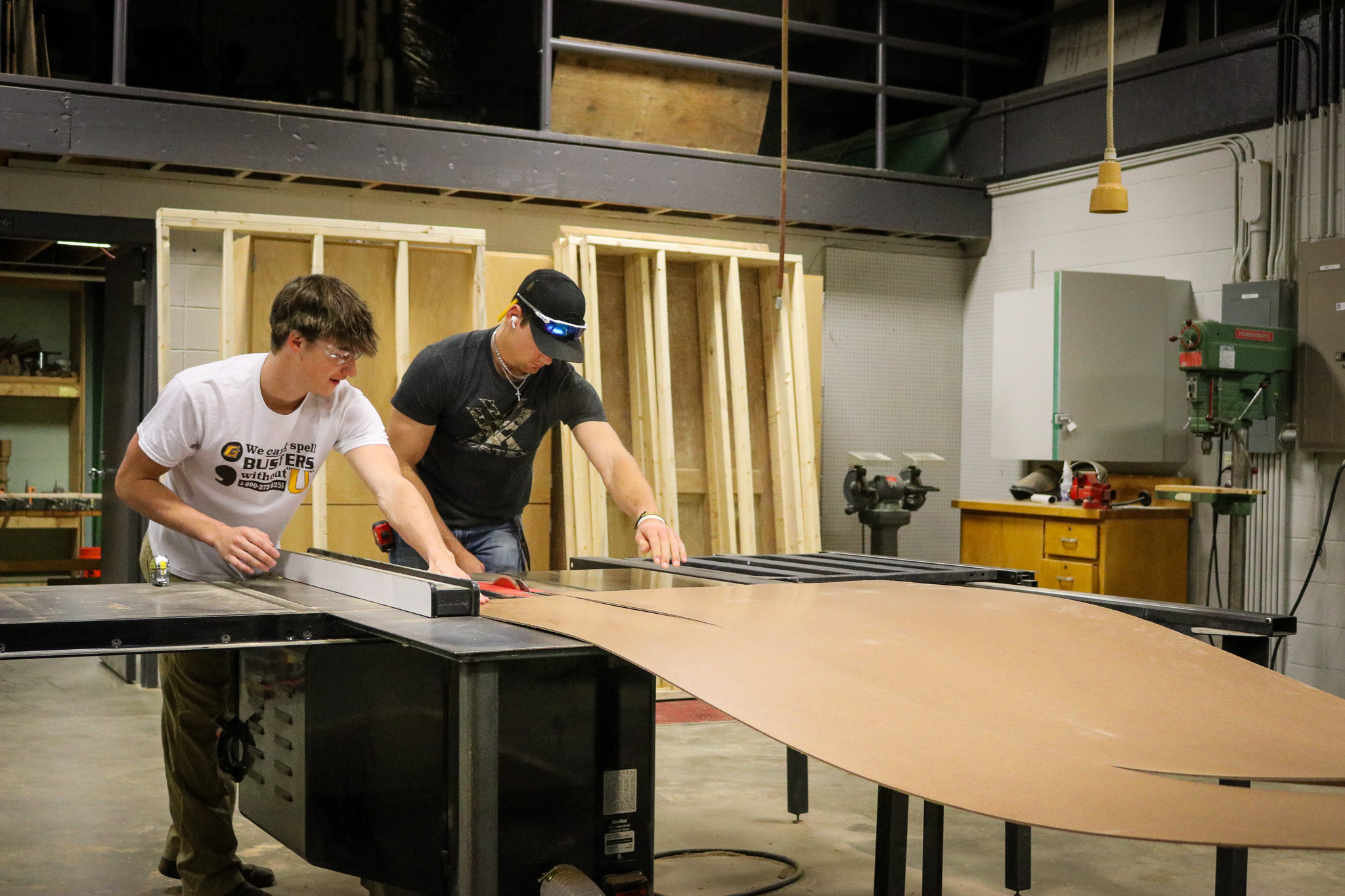 construction students cutting wood in class.