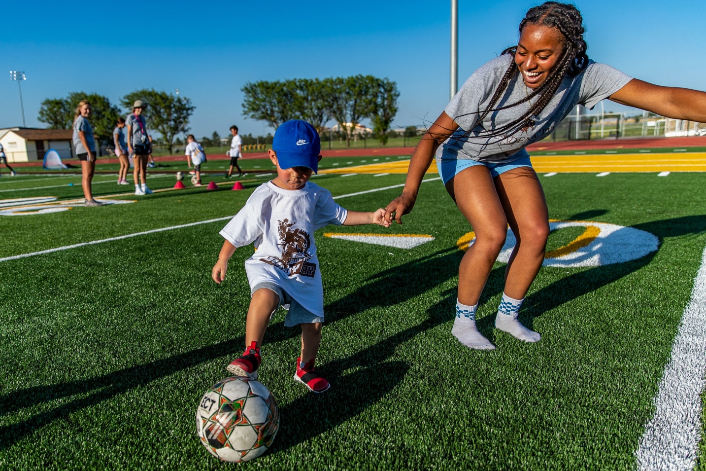 adult person and child playing recreational sport