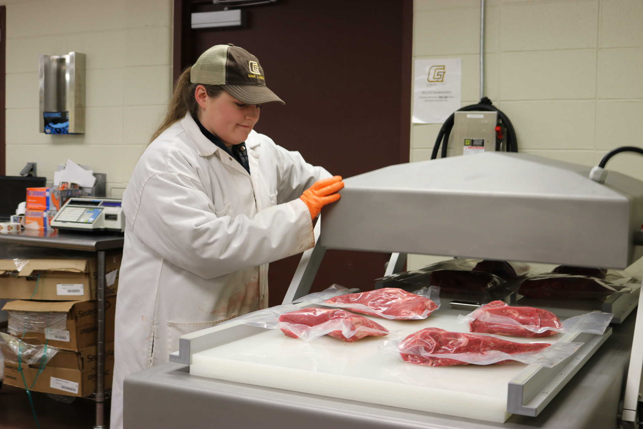 student working in meat lab.