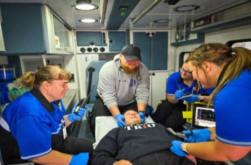 paramedic students practicing on student in ambulance.