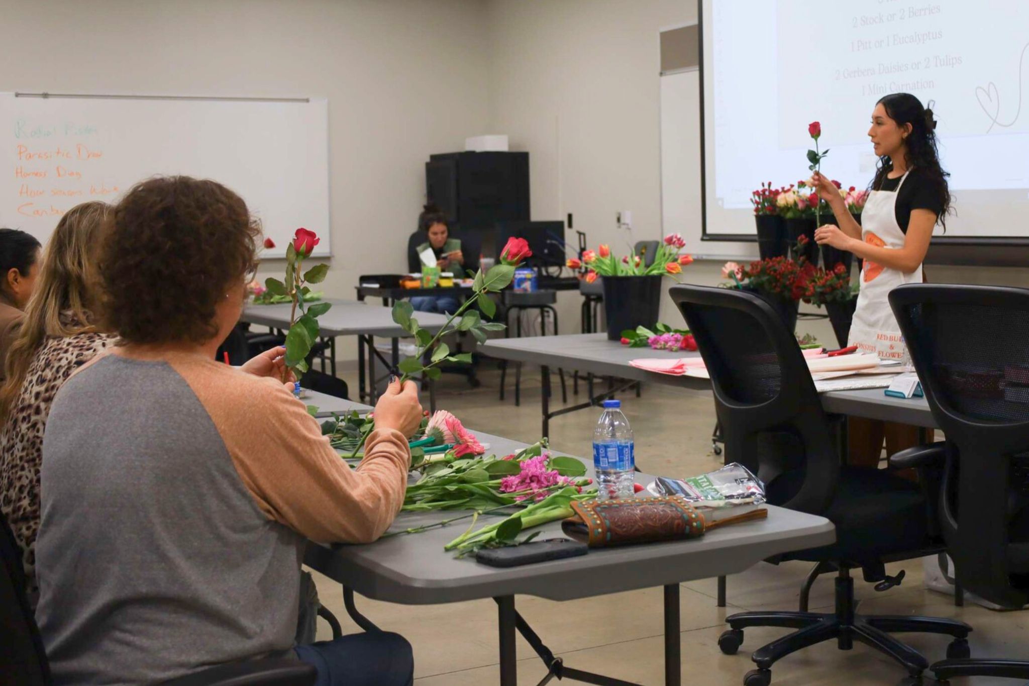 students creating rose boquets.
